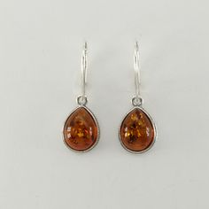 These is a beautiful pair of Sterling Silver Earrings with Baltic Amber. The earrings are made out of solid 925 Silver and there is no nickel or other substances causing most allergies. This makes the earrings hypo allergenic. Size of one Earring in total - with the hook - is  3.2 x 1.1 cm or  1.26 x 0.43 inch You will receive the item in a gift box - perfect to surprise someone or yourself. Usually we ship on the same day we receive the payment for the order. We want you to be happy with your p Nickel-free Classic Teardrop Earrings For Anniversary, Classic Teardrop Pear-shaped Earrings As Gift, Classic Amber Sterling Silver Earrings, Classic Teardrop Pendant Earrings For Anniversary, Classic Teardrop Earrings For Anniversary, Hypoallergenic Sterling Silver Teardrop Earrings For Formal Occasions, Hypoallergenic Sterling Silver Teardrop Earrings For Formal, Hypoallergenic Sterling Silver Teardrop Earrings, Classic Nickel-free Teardrop Earrings As Gift