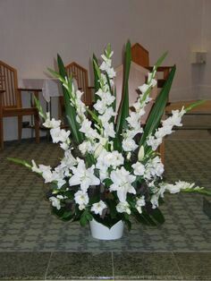 a vase with white flowers on a table