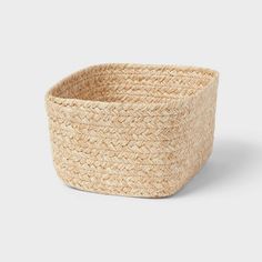 a large woven basket is shown on a white background, with the lid open and it's bottom half empty