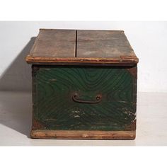 an old wooden box sitting on top of a white floor