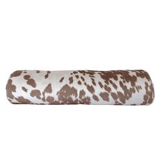 a brown and white spotted animal print pillow