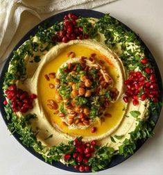 hummus with pomegranates and nuts on a plate