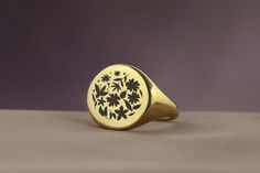 Embrace the timeless beauty of nature with this Engraved Flowers Bold Statement Round Signet Ring, a perfect expression of elegance and femininity. Designed for women who appreciate the delicate intricacies of floral designs, this ring features a round signet adorned with beautifully engraved flowers, making it an ideal gift for the nature-loving woman in your life. Crafted with care and precision, this piece combines the bold statement of a signet ring with the gentle allure of nature, offering Classic Round Flower Ring In 14k Gold, Classic 14k Gold Round Flower Ring, Classic Yellow Gold Flower Ring, Classic Yellow Gold Round Flower Ring, Nature-inspired Yellow Gold Flower Ring As Gift, Nature-inspired Yellow Gold Flower Ring For Gift, Nature-inspired Yellow Gold Flower Ring Gift, Nature-inspired Yellow Gold Flower Ring, Elegant Gold Signet Ring With Birth Flower