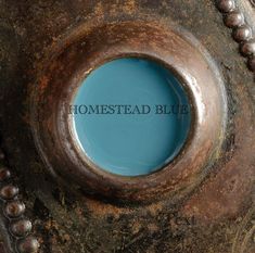 the word homestead blue is embedded in an old metal object