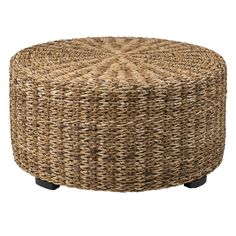 a round wicker ottoman with black legs and an intricate design on the top,