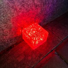 a red glowing object sitting on the ground