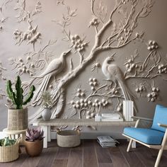 the wallpaper in this living room is decorated with birds and flowers, as well as potted succulents