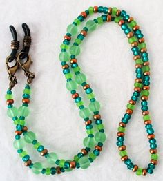 Green & Brown Beaded Eyeglass Chain 25" in length, made with glass beads, beading cord, metal lobster clasps, and adjustable rubber holders. Lobster clasps make it easy to change the rubber holders, and an extra pair of holders are included with every purchase. This Green & Brown Beaded Eyeglass Chain will arrive in a gift box, ready to give as a present or to keep and store. Back to Beaded Eyeglass Chains Adjustable Green Necklace For Everyday Use, Everyday Adjustable Green Necklace, Adjustable Colorful Beaded Jewelry For Everyday Use, Adjustable Beaded Chain Necklace For Everyday, Adjustable Round Beaded Necklaces For Everyday, Adjustable Round Bead Glass Necklaces, Adjustable Green Beaded Necklaces With Lobster Clasp, Adjustable Czech Glass Beaded Necklaces With Lobster Clasp, Adjustable Green Beaded Necklace With Lobster Clasp