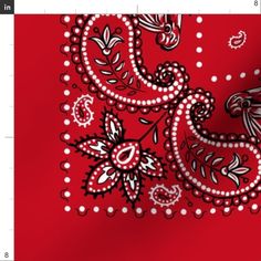 a red bandana with black and white paisley designs on the front, along with polka dots