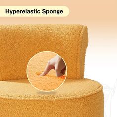 a yellow chair with a hand pointing at something on the back of it and an ad for hyperlastic sponge