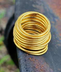 This is a solid 24k gold round band, approximately 1.1 MM+ in diameter. This is my best selling ring! I have sold thousands of them.  These rings are dainty but retain the unmistakable color of real 24k gold, and they have the true heft of pure 24k gold. Thanks for checking these out! Gold Spiral Stackable Rings, Gold Stackable Rings Made Of Recycled Gold, Gold Spiral Wedding Ring, Pure Gold Ring, Recycled Gold Ring, Handmade Wedding Band, Dainty Gold Ring, Womens Cuff Bracelets, Dainty Gold Rings