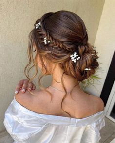 a woman with long hair wearing a white dress and flowers in her hair is seen on instagram