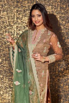 Caramel brown full sleeves A-line kurta with all over persian jaal embroidery using dori, thread and sequin highlights. Paired with a matching fleur embroidered palazzo and a contrasting green scallop border fleur motif embroidered organza dupatta. - Aza Fashions Brown Resham Embroidered Sets For Diwali, Festive Semi-stitched Beige Sharara, Brown Resham Embroidery Sets For Diwali, Brown Sets With Resham Embroidery For Diwali, Festive Beige Semi-stitched Sharara, Elegant Brown Festive Sets, Designer Wear Sets With Resham Embroidery In Brown, Brown Dupatta With Resham Embroidery For Navratri, Brown Designer Wear Sets For Diwali