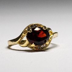 Gorgeous gold-plated faceted Garnet Crystal Ring-  January birthstone- with dazzling crystals.  size 9.75. It shines like real gold. GREAT Gift! No Tarnish It will come in a gift bag Formal Gold Garnet Birthstone Ring, Vintage Gold Garnet Birthstone Ring, Gold Ruby Ring With Gemstone Accents, Gold Ruby Ring With Gemstone Accents For Anniversary, Classic Gold Crystal Ring With Birthstone, Elegant Gold Faceted Birthstone Ring, Gold Faceted Ruby Ring For Anniversary, Gold Oval Crystal Birthstone Ring, Gold Oval Garnet Birthstone Ring