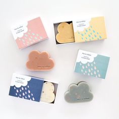 four soaps in boxes with rain and cloud designs on them, sitting next to each other