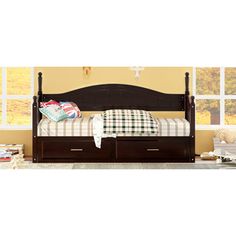 a bed with two drawers underneath it in front of a window next to a dresser