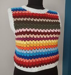 a multicolored crocheted sweater on a mannequin