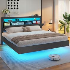 a bed with blue lights on the headboard and foot board is shown in this modern bedroom