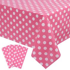 a pink and white polka dot tablecloth with matching napkins on the bottom half