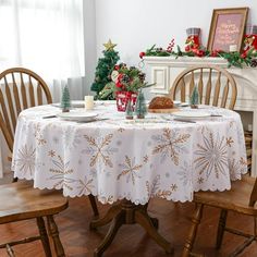 a table with two chairs and a christmas tree