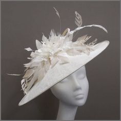 Stunning white and oyster disc fascinator (hatinator) decorated with fine loops of sinamay a beautiful assortment of feathers including trimmed ostrich quill, and a scattering of silver diamanté. Made on a headband.  This saucer style headpiece is ideal for race days / ladies day, weddings or formal functions. Please note this hat is made to order, orders take approximately 2-3 weeks to be made.  Designs can be made to order in a range of different colours or styles, see our colour chart: www.ja Edwardian Hat, Feather Fascinator, Wedding Hat, Wedding Fascinators, Elegant Hats, Feather Fascinators, Wedding Hats, Day Wedding, Race Day