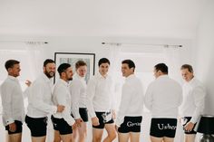 a group of men standing next to each other in shorts and shirts with the word u - he written on them