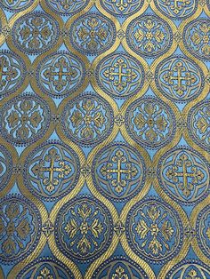 a blue and gold wallpaper with crosses on it