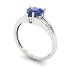 a white gold ring with a blue sapphire stone