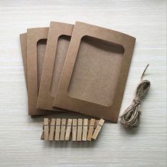 three brown paper bags and some string on a table