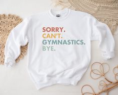 Gymnastics Shirt, Gymnastics T Shirt, Gymnastics Sweatshirt, Kids Gymnast, Girl Gymnastics Gift, Gymnastics Outfit, Gymnast Gift, Youth ⛺️Welcome to LifeOnCustomTees Etsy Shop! MADE TO ORDER especially for YOU!  This plush sweatshirt is soft and cozy and has the ideal loose fit.  Coupled with durable print, this sweatshirt will be a fast favorite for years to come.  Perfect for going on a hike, running errands, hanging out with friends, or just doing you!  Don't see your size or the color you de Playful Sports Tops With Letter Print, Gender-neutral White Tops For School, White Top With Funny Text For School, White Tops With Funny Text For School, Gymnastic Shirts, Gymnastics Sweatshirts, Gymnastics Gear, Gymnastics Wallpaper, Gymnastics Stuff