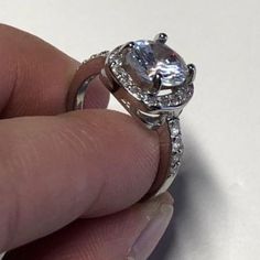 This ring is FULL OF BLING! Sterling Silver Plated Ring with white cubic zircon stones. Square set surrounded by small white cubic zircon stones stacked with a 2 CT cushion cut center white cubic zirconia stone. Channel setting. This is a SIZED ring, please see available sizes. VIDEO: https://www.facebook.com/wickedwondersVIPbling/vid... #Princess #Bling #RingBling Diamond White Princess Cut Crystal Promise Ring, Cubic Zirconia Princess Cut Promise Rings, Princess Cut Cubic Zirconia Promise Rings, White Moissanite Crystal Ring With Round Cut, Promise Princess Cut Birthstone Ring With Cubic Zirconia, White Gold Cubic Zirconia Princess Cut Birthstone Ring, Cubic Zirconia Princess Cut Ring With Center Stone, Princess Cut Cubic Zirconia Ring With Center Stone, White Cubic Zirconia Diamond Ring For Promise