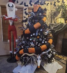 a decorated christmas tree in the shape of a beetle and jack - o - lantern