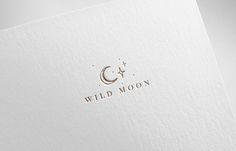 the wild moon logo is shown on top of a white paper