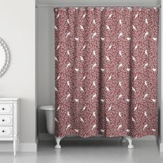 a shower curtain with birds on it in a bathroom next to a dresser and mirror