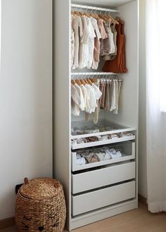 an organized closet with clothes and baskets