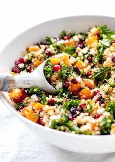 a white bowl filled with food on top of a table