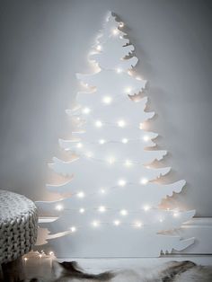 a white christmas tree with lights on it