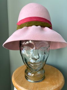 "From my longtime personal collection comes this stylish, powder pink hat by Christian Dior Chapeaux, circa 1960s Crafted from soft, supple fur felt, with a high, pleated crown, a wide brim that is subtly gathered from ear to ear (but not in back), and a striking band of dusty rose and olive green suede leather  Easily shaped for a variety of looks and vibes Matching powder pink interior sweat band, a designer label the reads \"Christian Dior chapeaux Paris-New York\" and the inside crown is sta Fur Felt Hat With Curved Brim For Spring, Spring Fur Felt Hat With Curved Brim, Spring Wide Brim Fur Felt Hat, Spring Fur Felt Brimmed Hat, Spring Brimmed Fur Felt Hat, Spring Curved Brim Fur Felt Hat, Spring Fitted Fur Felt Hats, Pink Wide Brim Hat For Winter, Fitted Pink Brimmed Felt Hat