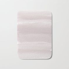 a white bath mat with watercolor stains on it