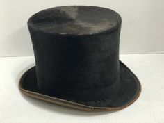 Antique Lincoln Bennett Top Hat This is quite an old top hat.  It's most likely silk.  The inside measurement is 22 1/16".  It is 6 ¾" tall.  There are some signs of age with some wear on the top edge, a split near the top, and wear to the grosgrain ribbon on the band and the edge.   It has a fur appearance and the very top has a circular pattern in the way the silk lies.  The inside of the hat has a very thick sweat band and a paper interior where the label is.  The underside brim shows the fab Circular Pattern, Top Hat, Grosgrain Ribbon, Hat Fashion, Hats, Pattern