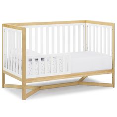 a wooden crib with white sheets on the bottom and sides, in front of a white background