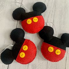 two mickey mouse ears with yellow buttons on them