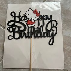 a hello kitty birthday cake topper on a stick