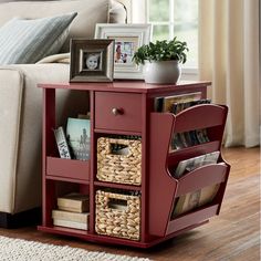 a living room with a couch, table and pictures on the shelf next to it