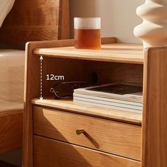 a bed with a wooden headboard and two glasses sitting on top of it next to a book shelf