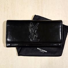 Black Patent Leather Yves Saint Laurent Bifold Wallet With Double Snap Closure And Ysl Logo Stitched On The Front. Back Zip Pocket And Plenty Of Room Inside For Cards, Cash, And Coins. In Excellent Condition Please See All Pictures. Absolutely Authentic And Comes With Dustbag Pictured. Bags Ysl, Snap Wallet, Ysl Logo, Yves Saint Laurent Bags, Bifold Wallet, Black Patent Leather, Snap Closure, Patent Leather, Yves Saint Laurent