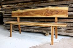 a wooden bench sitting on top of a pile of wood