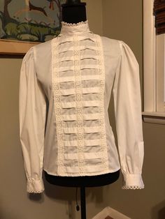 I am offering a late 1960s Lanz blouse. The blouse features front rows of tux and lace. It has a high stand up collar. It buttons in back. Womens Blouses, Late 1960s, Stand Up Collar, High Collar, Front Row, Womens Clothing Tops, Stand Up, Blouses For Women, 1960s