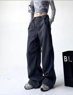 Features: Upgrade your style with our Y2K cargo pants. Made for women who love streetwear fashion, these high waist pants are perfect for fall. The loose fit allows for comfort and flexibility, while the lace up design adds a touch of playfulness. Stay on trend with our American retro trousers, featuring a wide leg silhouette. Trendy Cargo Style Parachute Pants, Y2k Style Cargo Pants For Fall Streetwear, Y2k Cargo Pants For Fall Streetwear, Wide-leg Drawstring Pants For Streetwear, Baggy Y2k Parachute Pants For Fall, Y2k Straight Cargo Pants With Cargo Pockets, Drawstring Wide-leg Pants For Streetwear, Streetwear Wide-leg Pants With Drawstring, Y2k Style Baggy Parachute Pants For Fall