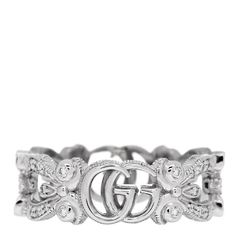 This is an authentic GUCCI 18K White Gold Diamond Flora Pave Ring size 48 or 4.5. The ring is crafted of 18 karat white gold and features an ornate band accented with the signature GG logo and flower motifs set with round brilliant cut diamonds, approximately .35 total carat weight. Luxury Diamond Cut Diamond Ring, Gucci Gold Wedding Ring, Gucci Gold Rings For Wedding, Gucci Sterling Silver Ring, Classic Gucci Sterling Silver Rings, Gucci Fine Jewelry With Diamond Accents, Gucci Jewelry With Diamond Accents For Gift, Luxury Diamond Ring With Decorative Band, Gucci White Gold Sterling Silver Ring